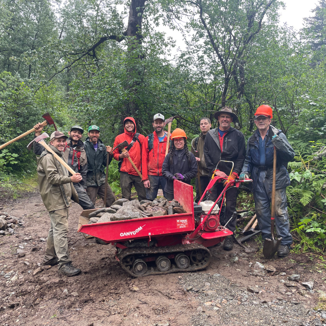 Crew members and Volunteers pose with a Canycom and tools